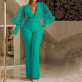 Red women's jumpsuit with mesh stitching on long sleeves, elastic waist, and wide leg trousers.