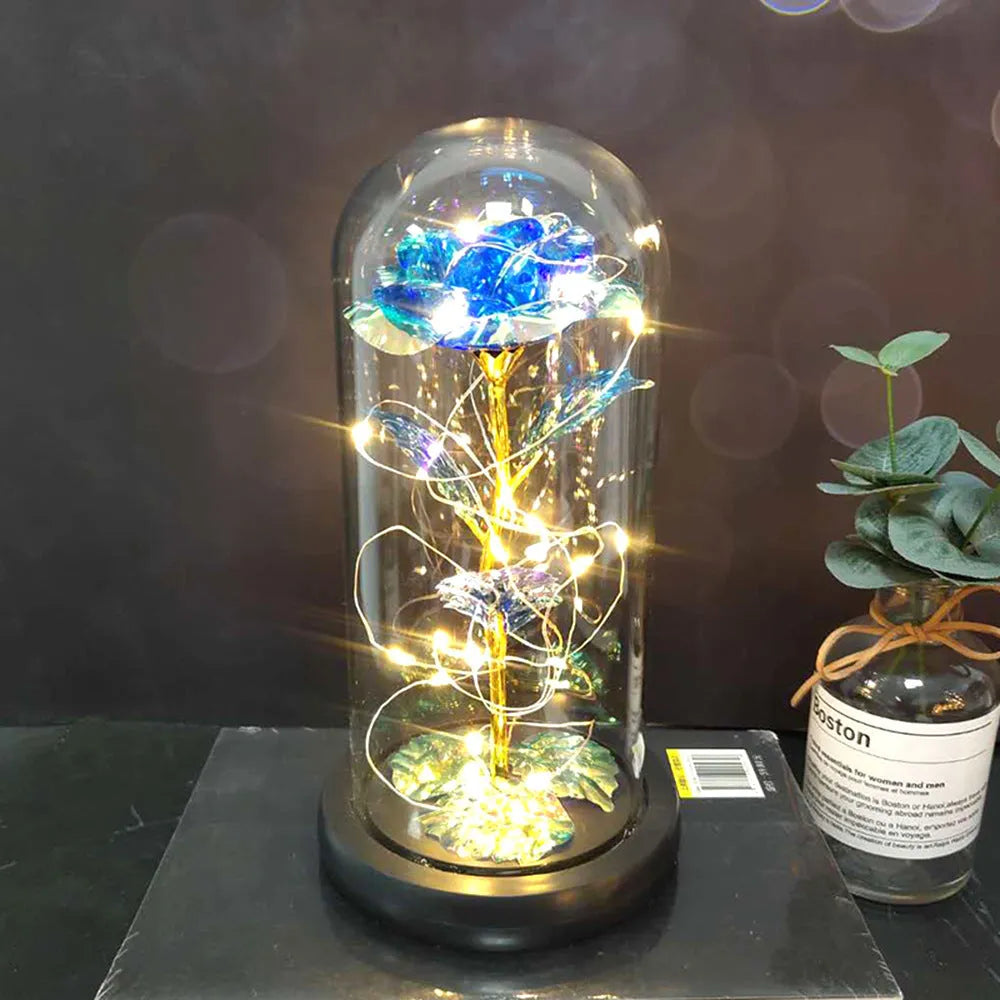 Simulated scarlet rose LED bouquet glowing inside a glass dome on a wooden base.