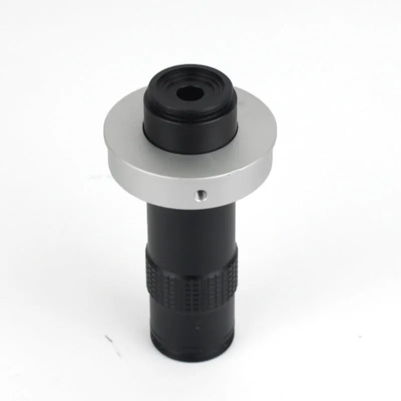 Black industrial monocular camera lens for 0.1-1.3X magnification with 60-300mm working distance.