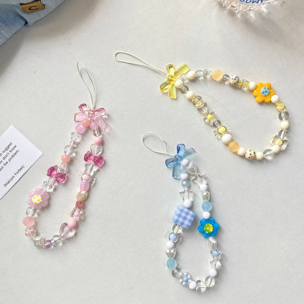 Plastic beaded mobile phone lanyard with floral charms in blue, pink or yellow colour options