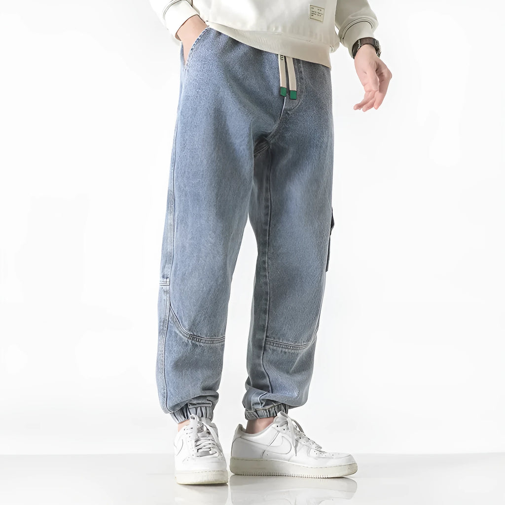 Men's cotton loose-fit tapered trousers in black colour showing mid-waist design and tapered leg silhouette
