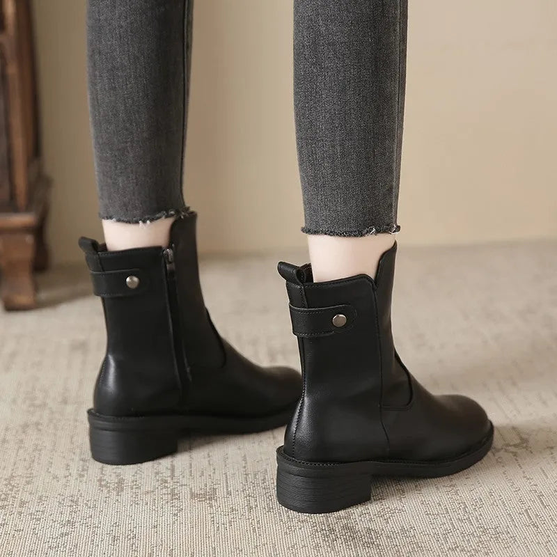 Black women's short boots with a side zip, round toe, and low rubber heel on a neutral background.