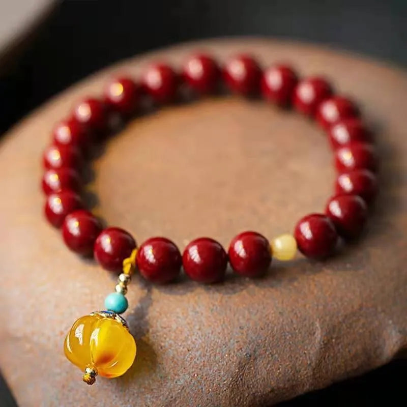 Handmade cinnabar bracelet with copper bead accent in wave shape, unisex design, available in pumpkin or brand cinnabar