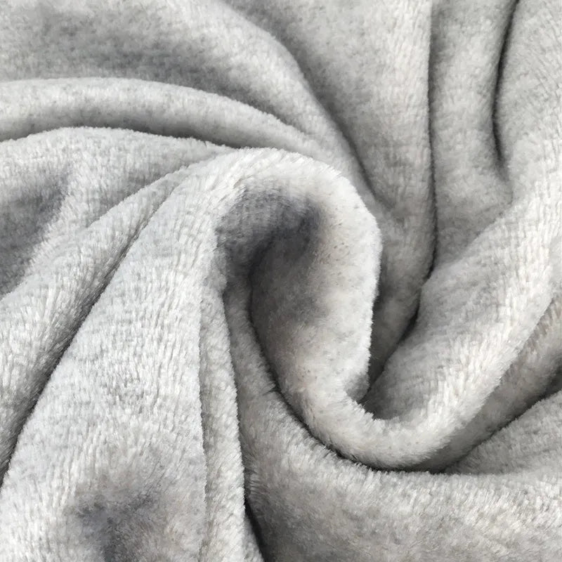Grey flannel dog blanket 70 by 100 centimetres on a soft surface