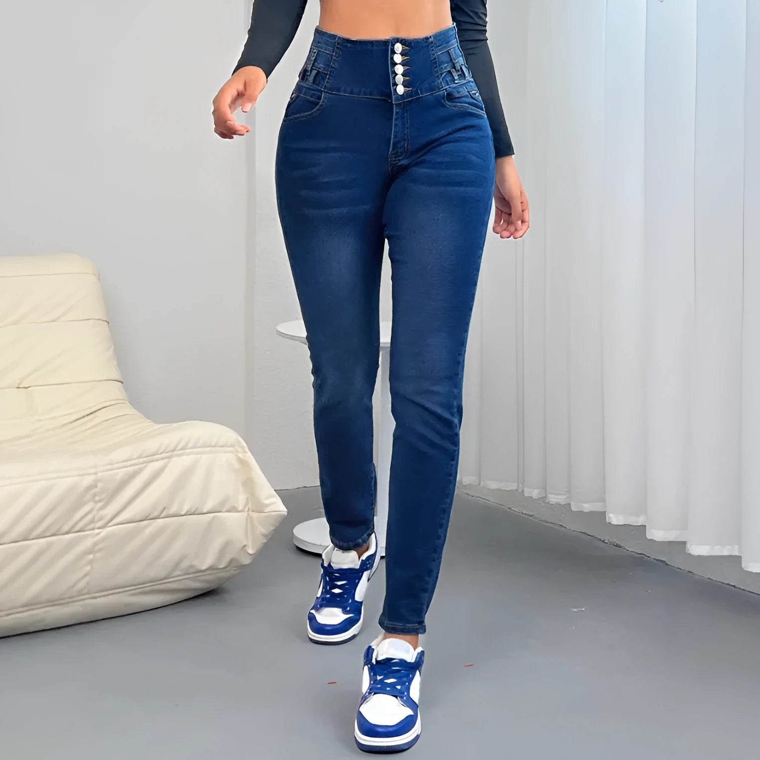 Women's dark blue straight-leg denim trousers with front button fastening showing skinny fit
