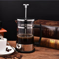 Glass manual pour-over coffee maker with stainless steel filter and separate glass flask, 350ml capacity.