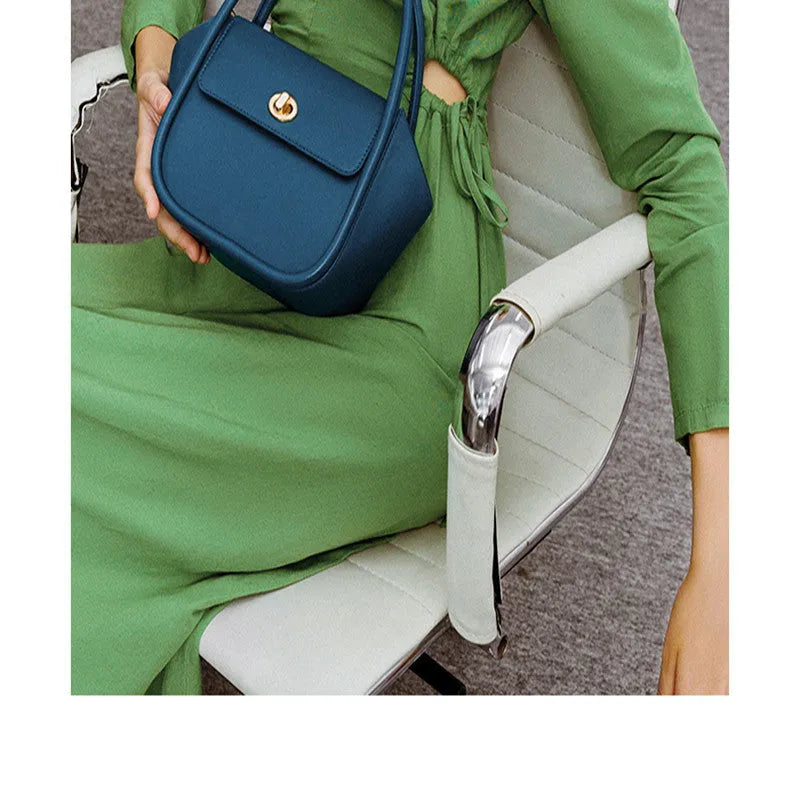 Women's wing-shaped cow leather tote handbag with a buckle closure in a choice of four colours.