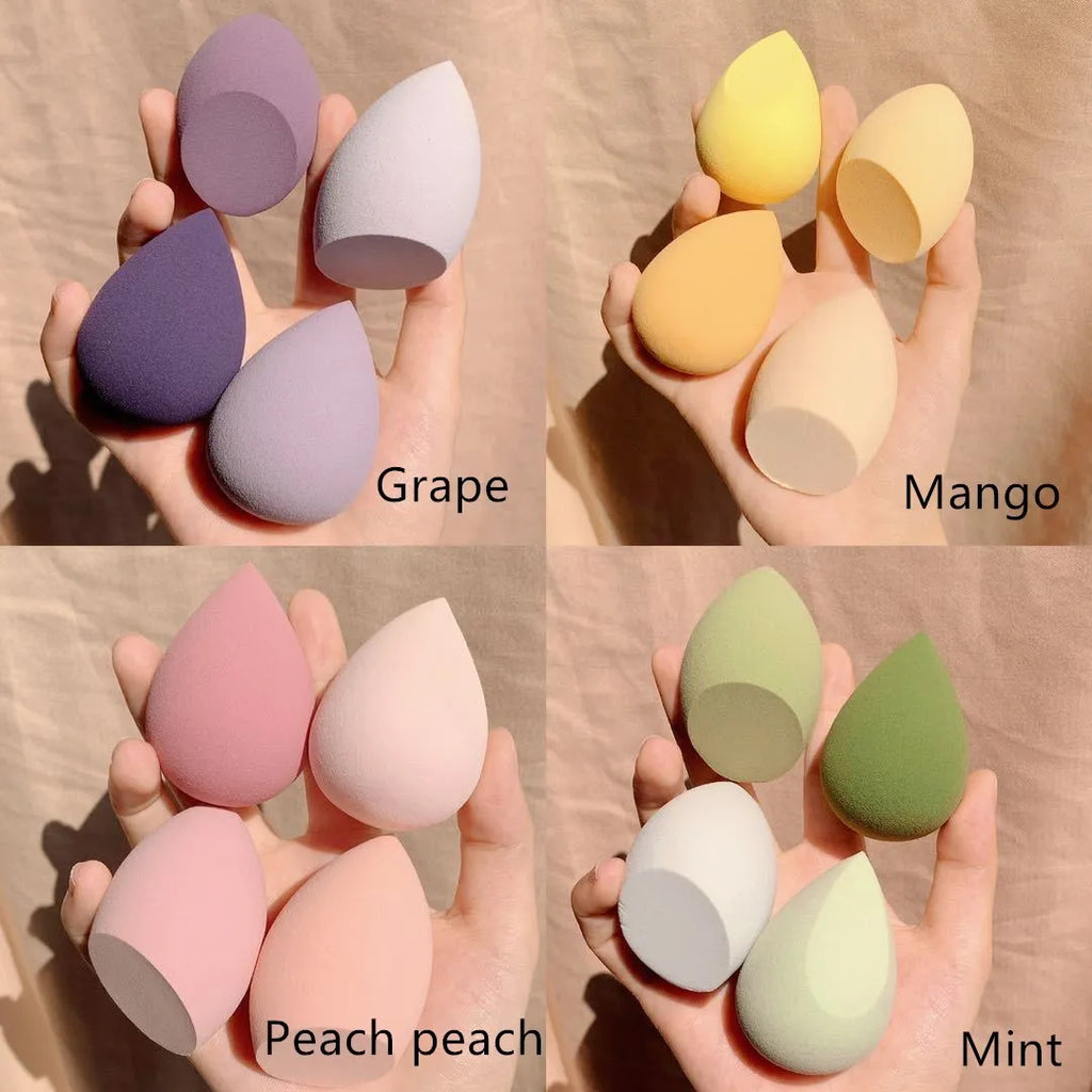 Four synthetic makeup sponges in grape, mango, mint, and peach colours, each measuring 6cm