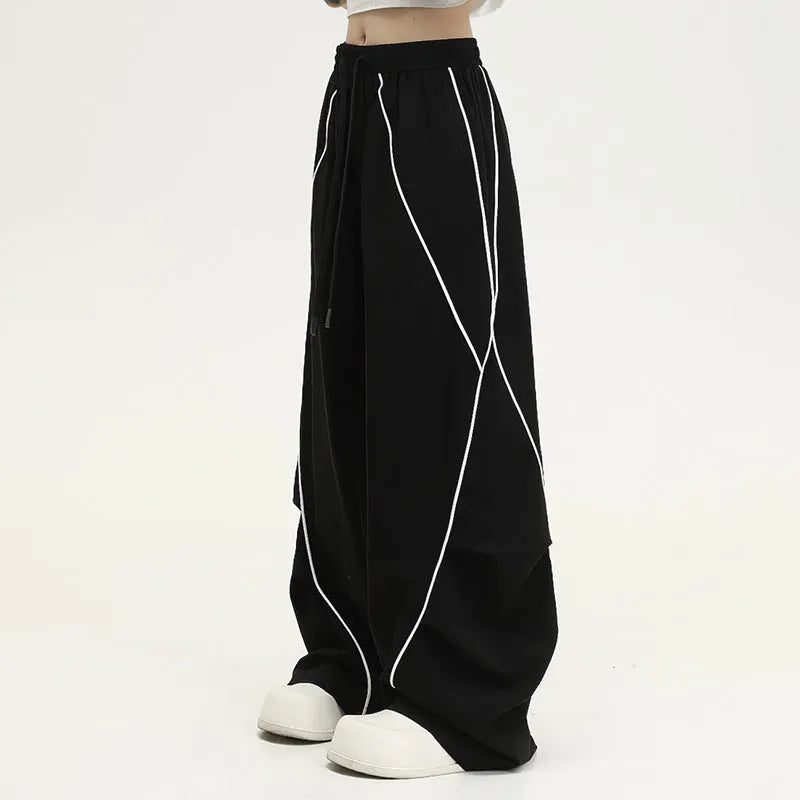 Black pleated hip hop sports pants with stripe pattern showing wide-leg design and mid-waist fit