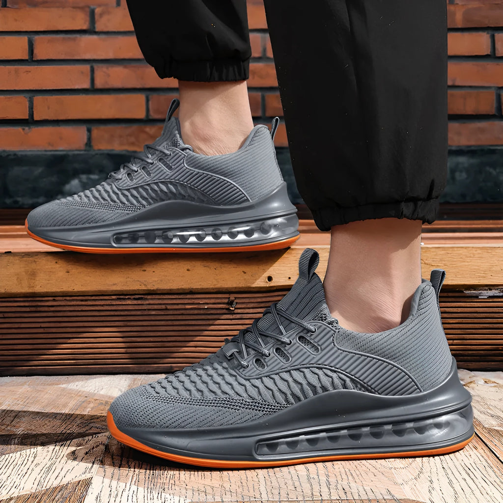 Men's black mesh low-top running shoes with white rubber sole on a plain background.