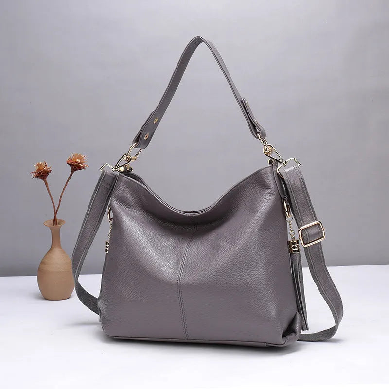 Genuine leather vertical square crossbody bag showing multiple internal pockets including a zipper changing bag and mobile phone pocket.