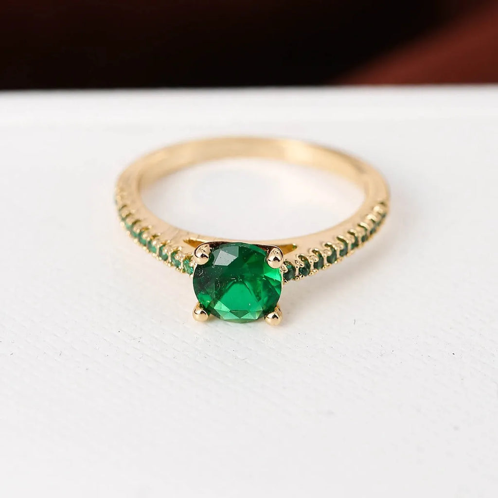 Geometric hexagon design copper zircon ring in various electroplated colours on a size guide.
