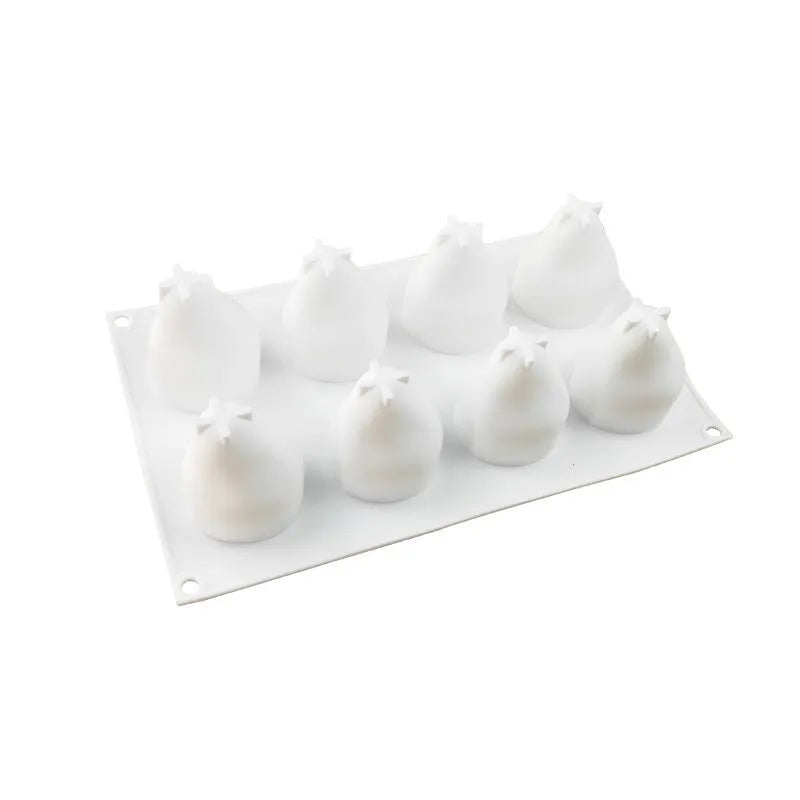Silicone baking molds in pineapple, pear, and pine cone shapes for making mousse cakes and desserts.