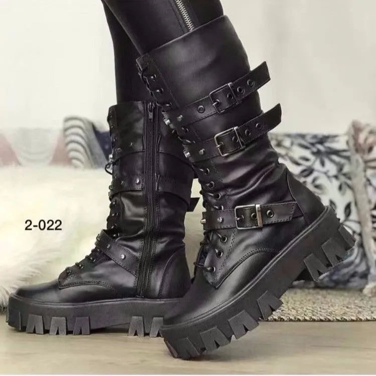Women's black mid-calf buckle boots with side zipper and round toe on wooden floor