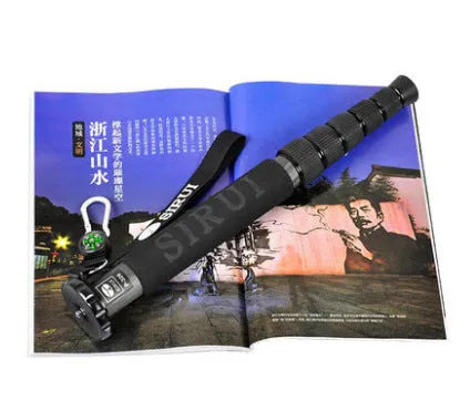 Black carbon fibre telescoping camera monopod extended to its full height.