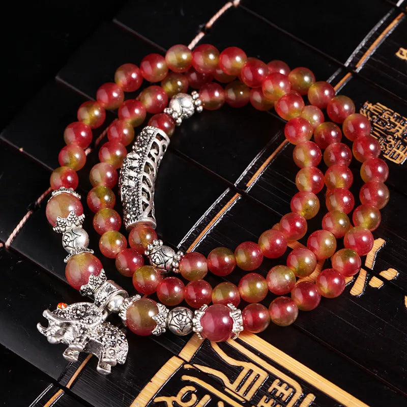 Natural watermelon crystal Chinese knot bracelet with elephant style beads.