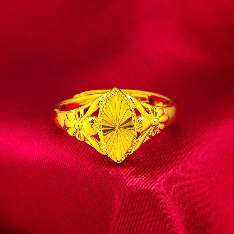 Open geometric flower ring in gold colour with textured details on brass base