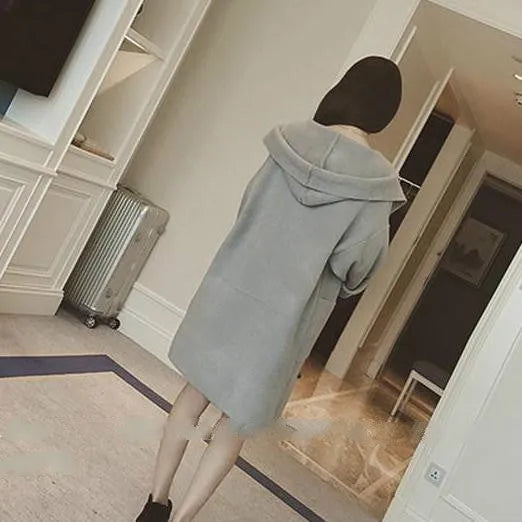 Plus size woman wearing a loose-fitting thin gray coat with long sleeves and lace detail.