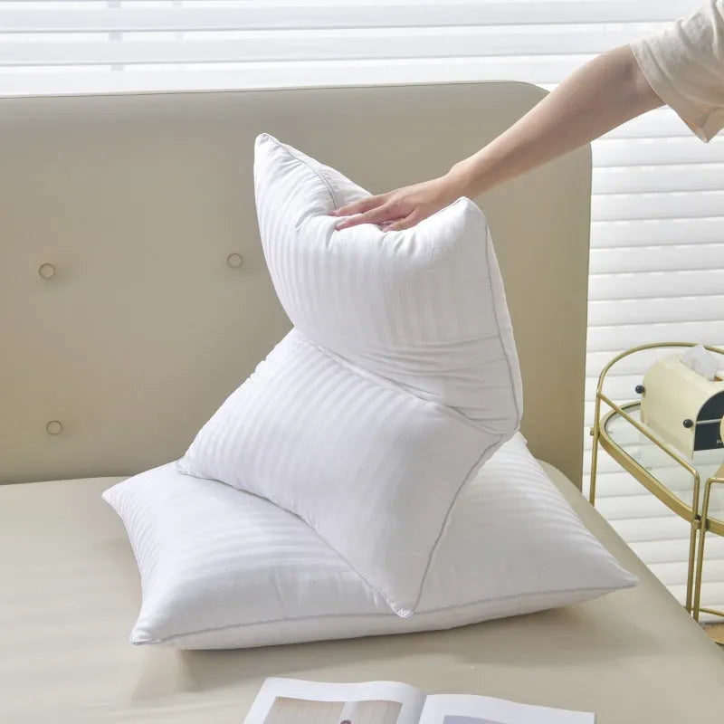 White feather pillow with cotton satin stripe pillowcase showing three size options