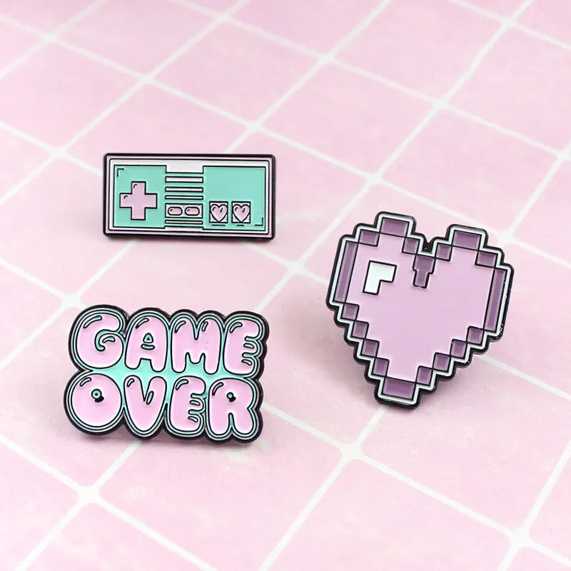 Stereo game console alloy pin badge in three colour options CC1122 CC1123 CC1124 on white background