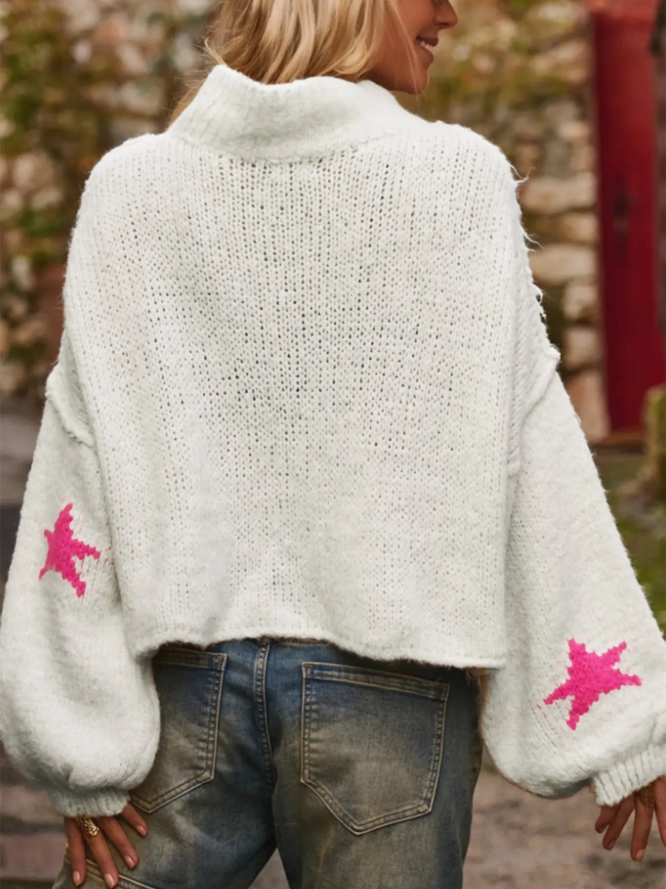 White women's loose turtleneck pullover sweater with a thick imitation velvet fabric and a contrast colour five-pointed star pattern.