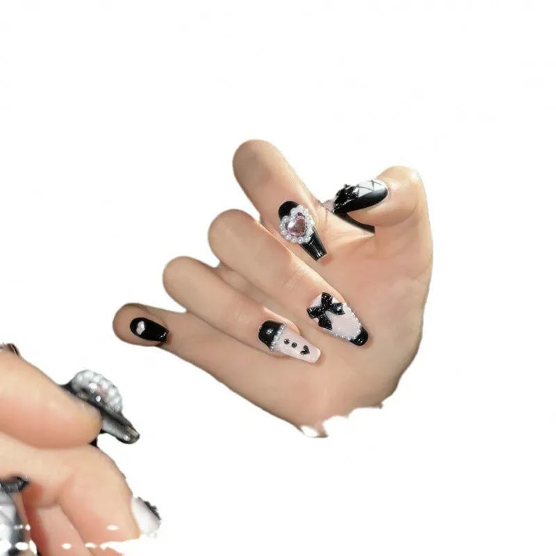 Black peach heart hand-painted artificial nails with cat's eye design in plastic storage case