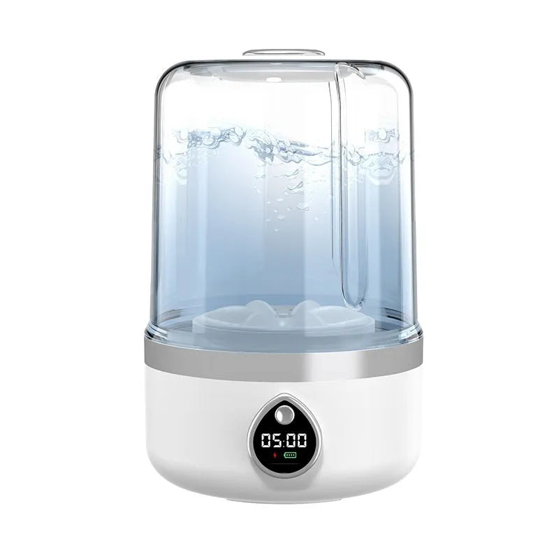 White plastic portable mini washing machine with USB cable on a countertop.