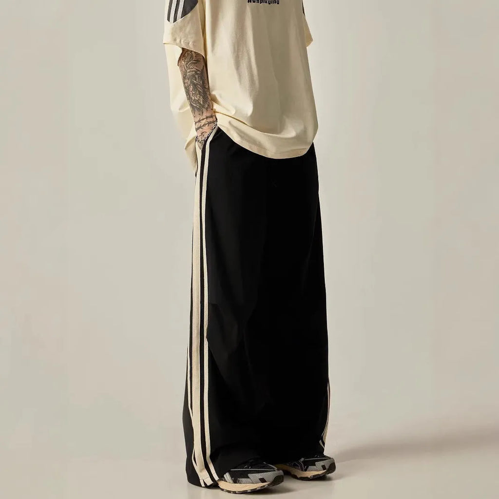 Black wide leg climbing trousers for men showing high waist and straight leg design on hanger.