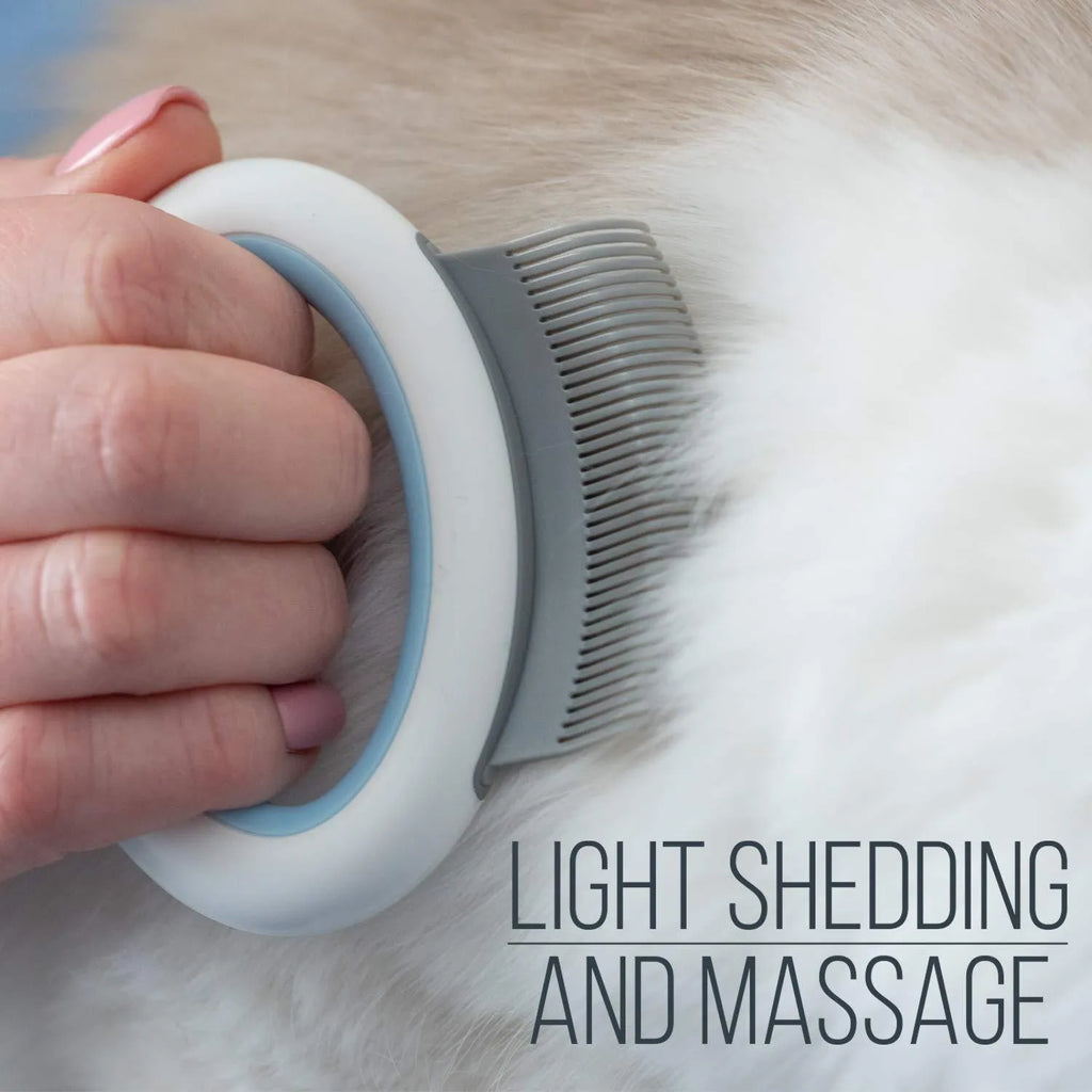 Blue plastic pet grooming comb with soft teeth and an ergonomic handle on a white background.