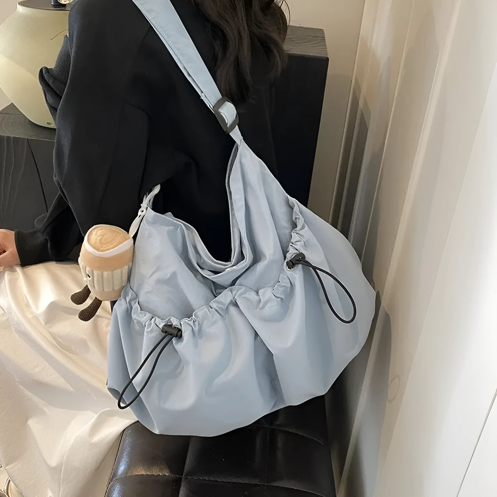 Green ultra-light pleated crossbody bag made of soft polyester fabric with a folding design.