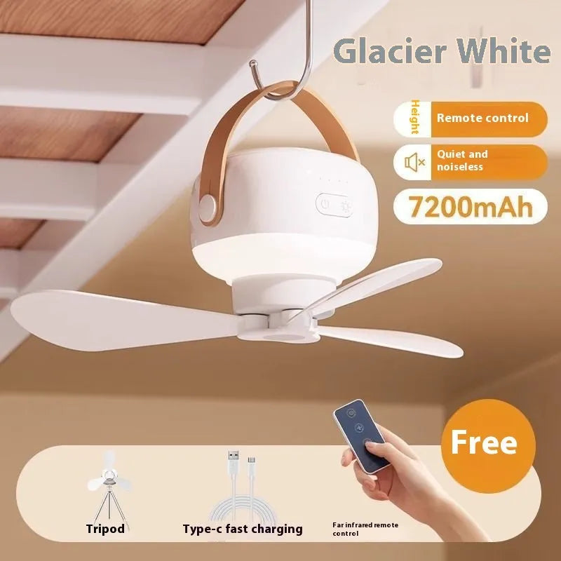 Small rechargeable electric fan for camping tent with night light on, hanging from a strap