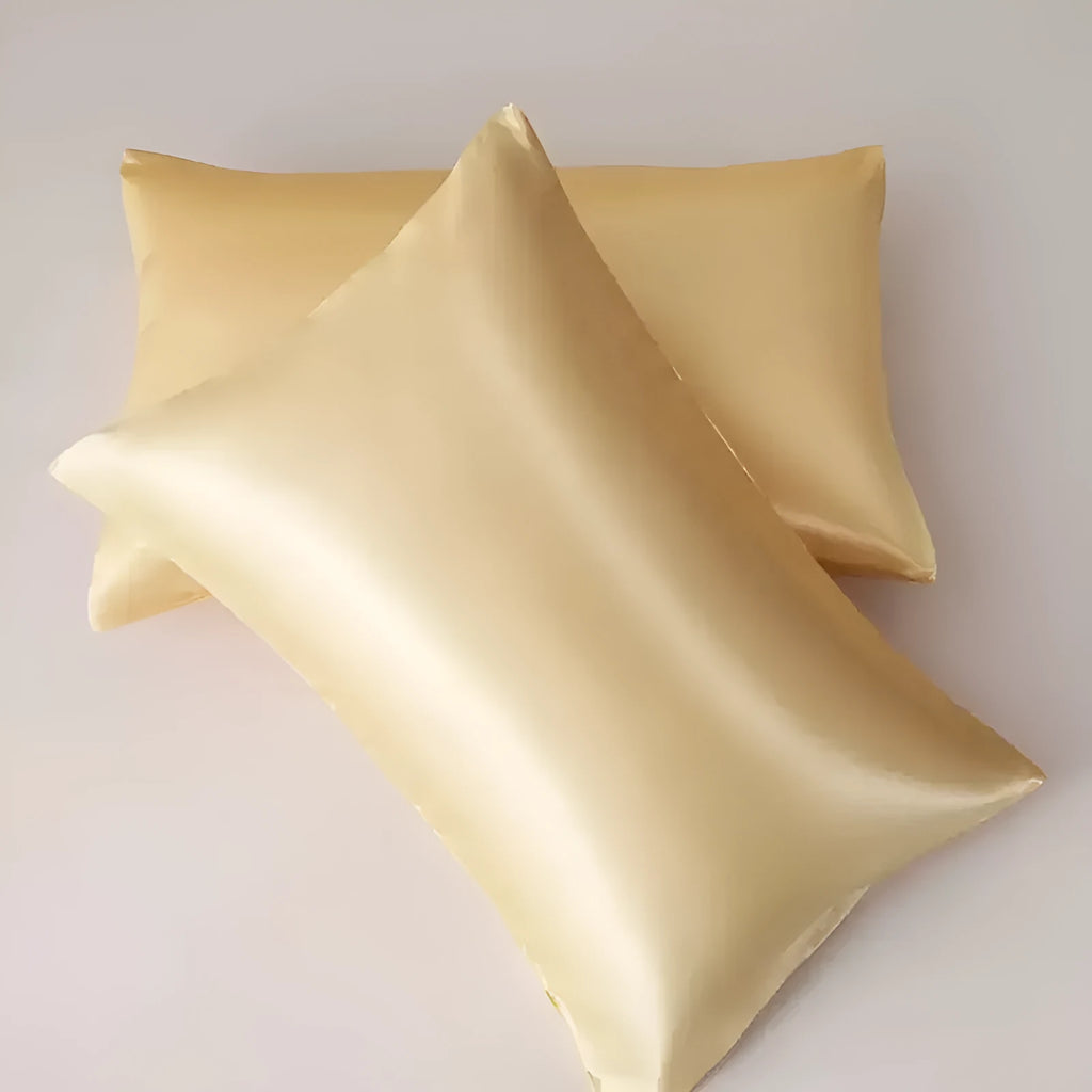 A pair of solid colour satin cloth pillowcases made from polyester, shown in one of thirteen available shades.