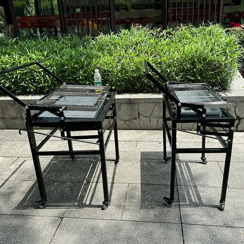 Foldable large charcoal barbecue grill shown in a garden setting