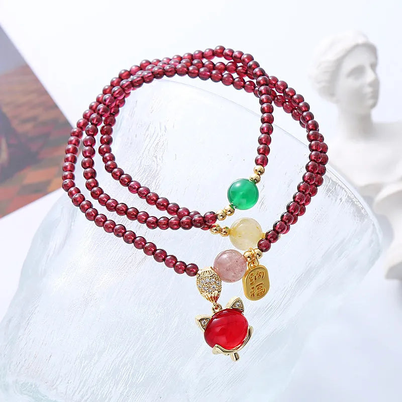 Natural crystal fox bracelet for women with purplish red garnet pendant on adjustable rope