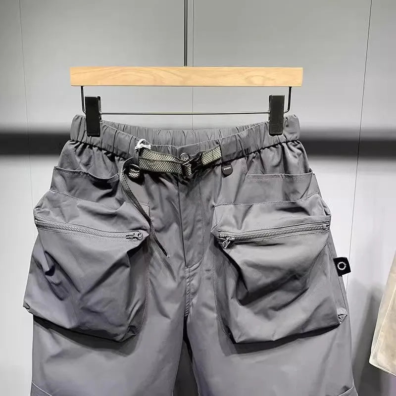 Man wearing large size loose fit black casual shorts with pockets.