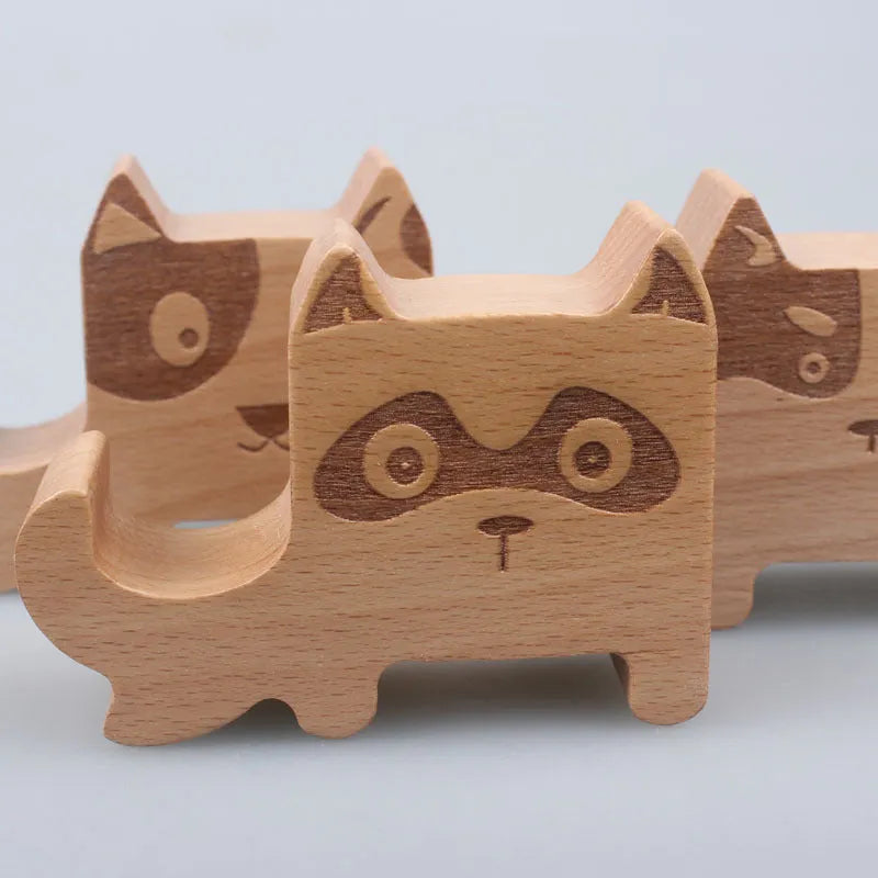 Creative resin mobile phone holder with beech wood base showing animal and character design options