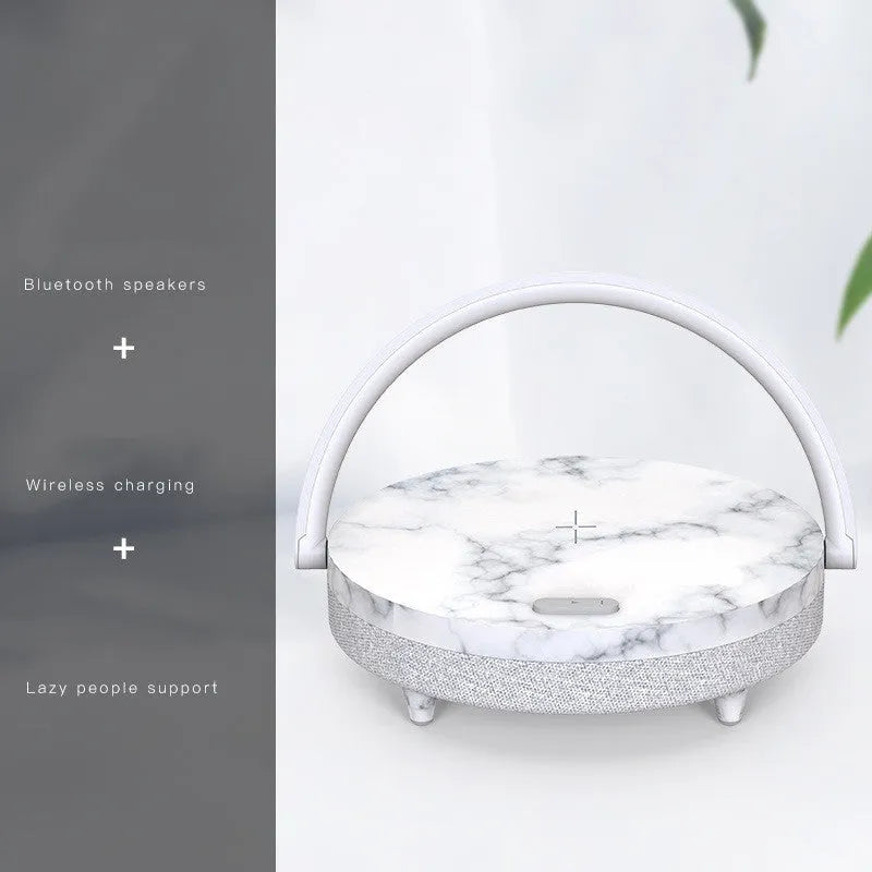 White multifunctional bedside lamp with wireless charging pad, Bluetooth speaker grille, and integrated phone holder in marble pattern finish.