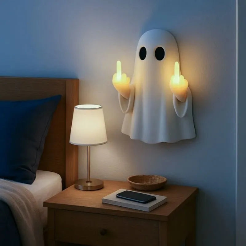 White plastic ghost night lamp with light on, on a flat surface