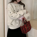 Women's loose grey acrylic pullover sweater with love pattern embroidery on the front.