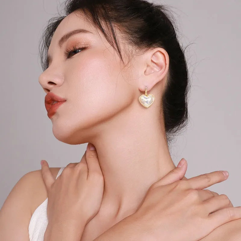 A pair of gold-coloured alloy ear clips for women in a natural style.