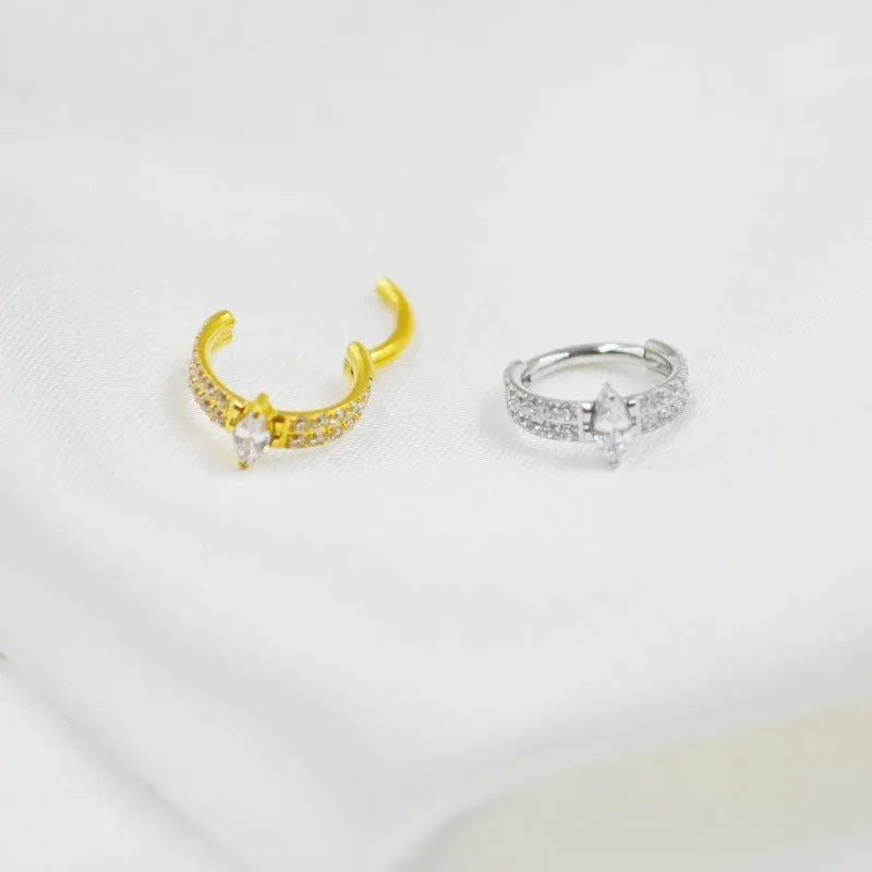 Close-up of a heart-shaped zirconia earring on a 316L steel post in silver tone.