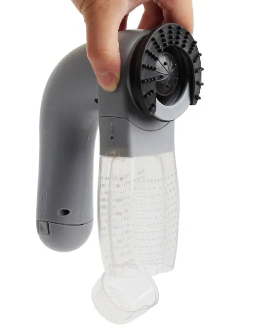Grey portable electric pet hair remover brush with soft rubber head for grooming dogs and cats.