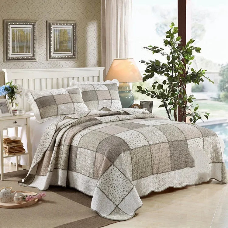 Washed pure cotton quilted bedspread and pillowcase set in a beige colour on a bed.
