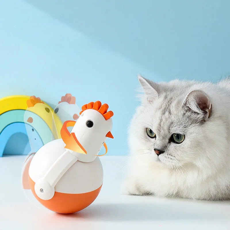 Green and orange electric cat toy with laser light feature on a wooden floor.