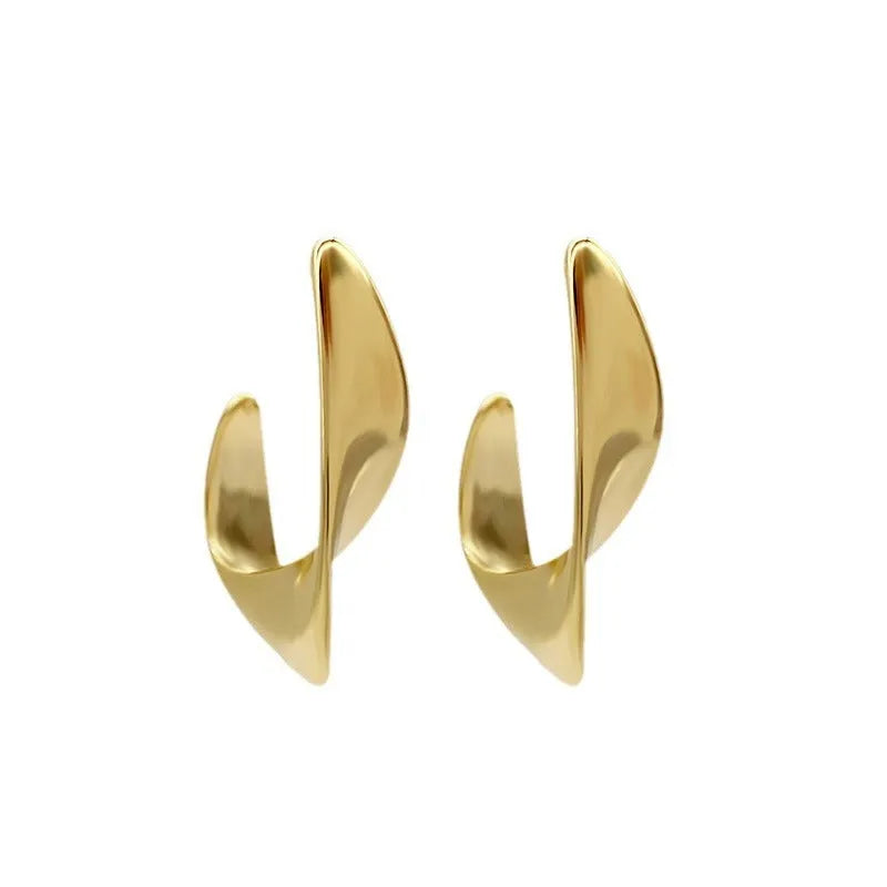 Geometric twisted metal earrings with electroplated gold or silver finish and round design elements