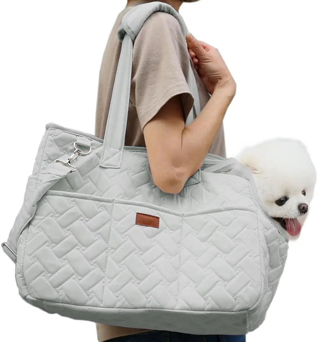 Grey pet carrier handbag with mesh panels and a safety tether for a small dog.