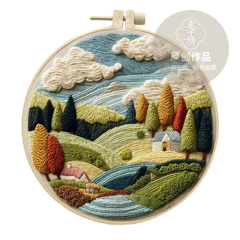 Embroidery kit with printed landscape design fabric, coloured thread, needles, and bamboo frame