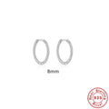Close-up of twisted sterling silver hoop earrings showing the textured string design.