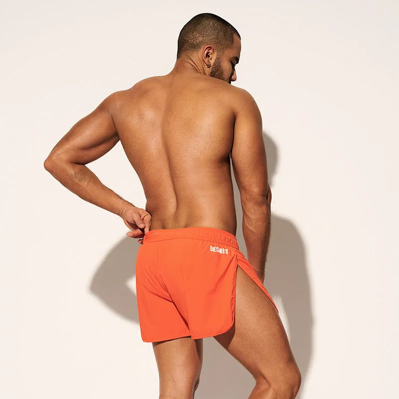 Men's loose fit polyester beach surfing shorts in fluorescent green with micro-elastic waistband