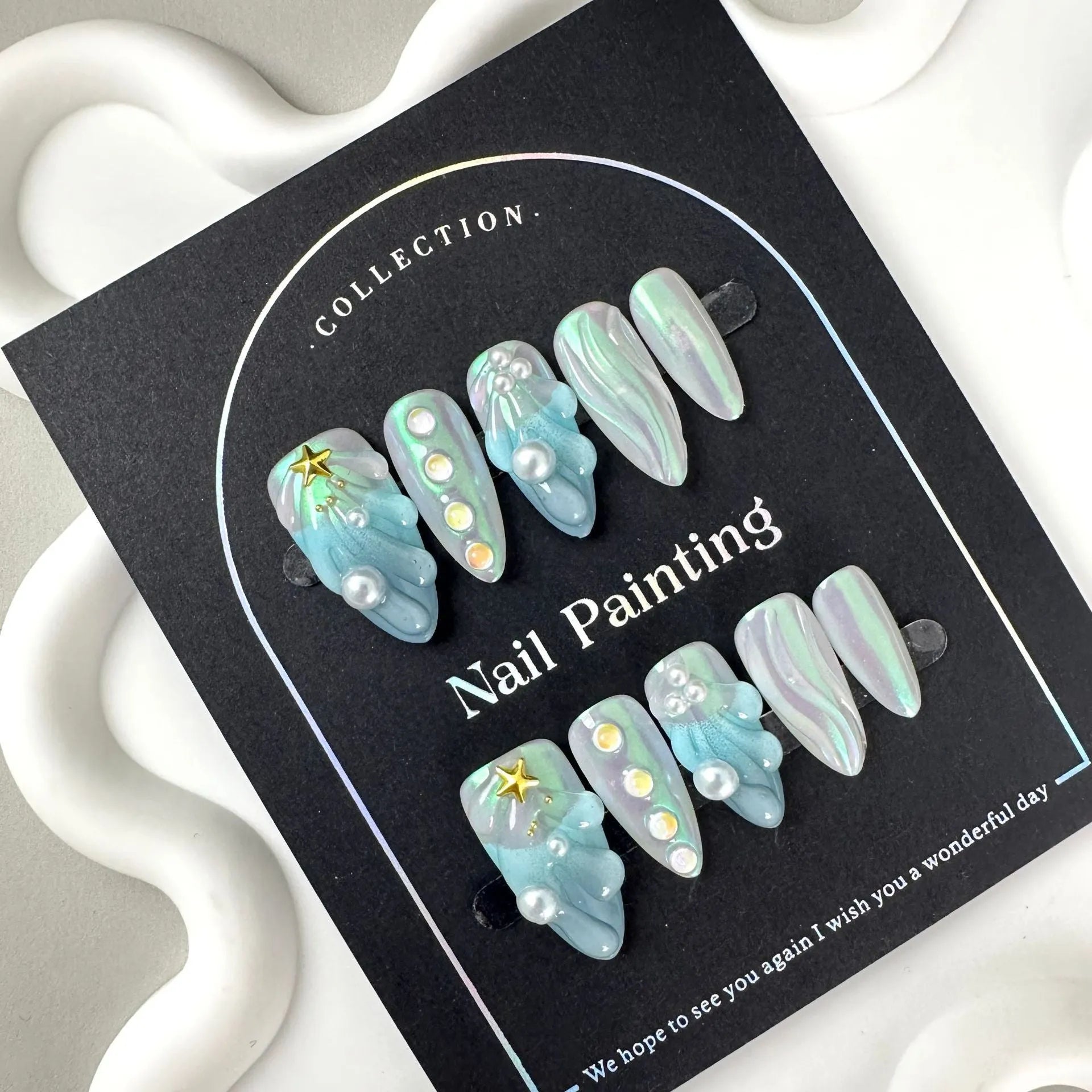 HAILANG blue plastic shell nail sticker set in sizes XS, S, M, L on a white background.